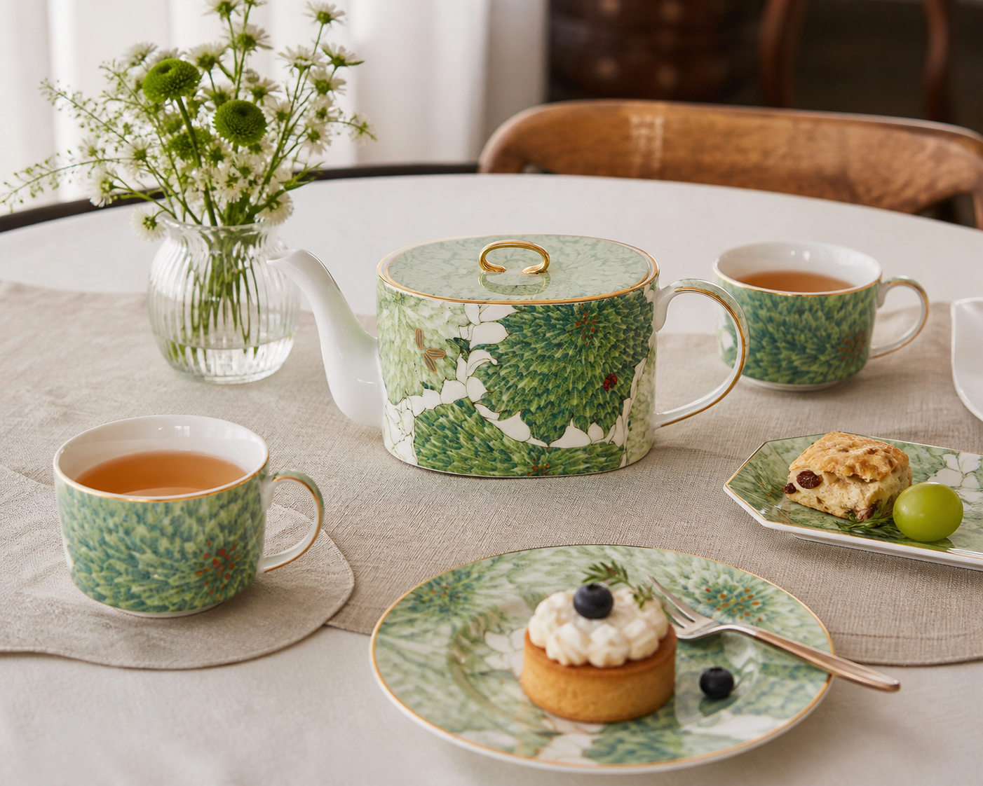 Chasing Light teapot with matching tableware on a realistic hosting table