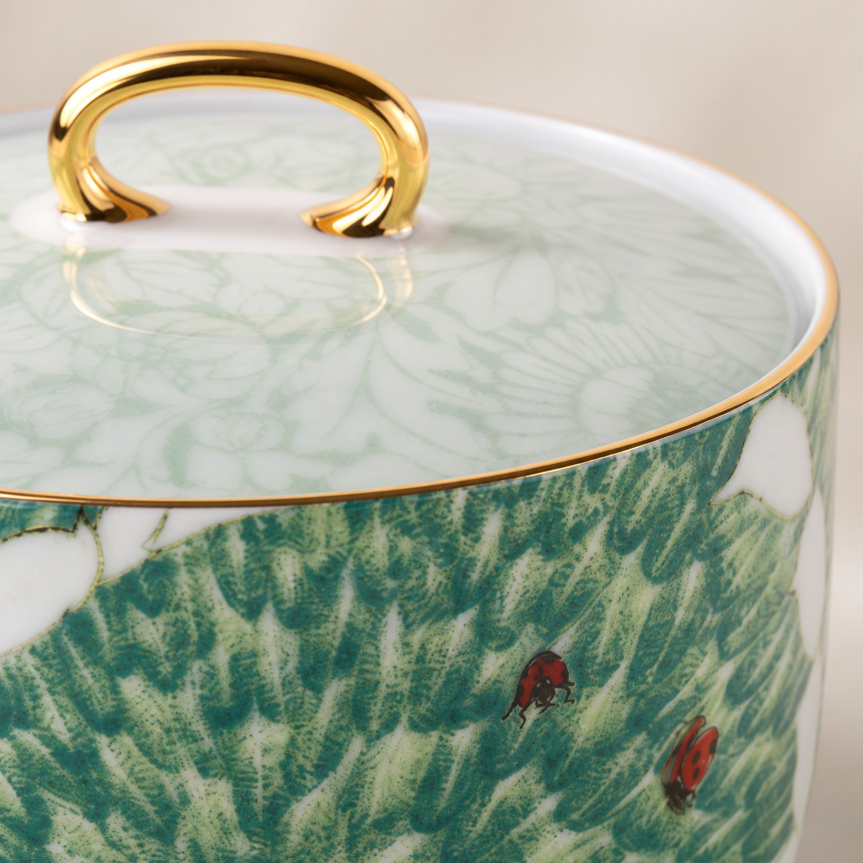 Close-up of Chasing Light sugar bowl lid, flat decal, ladybird and restrained gold detail