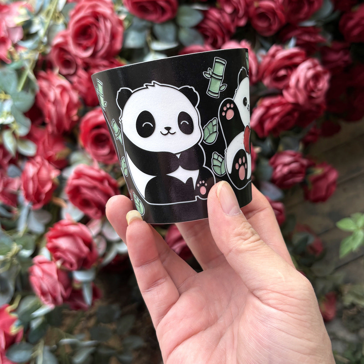 Solo Panda Choko Cup — real handheld photo with roses